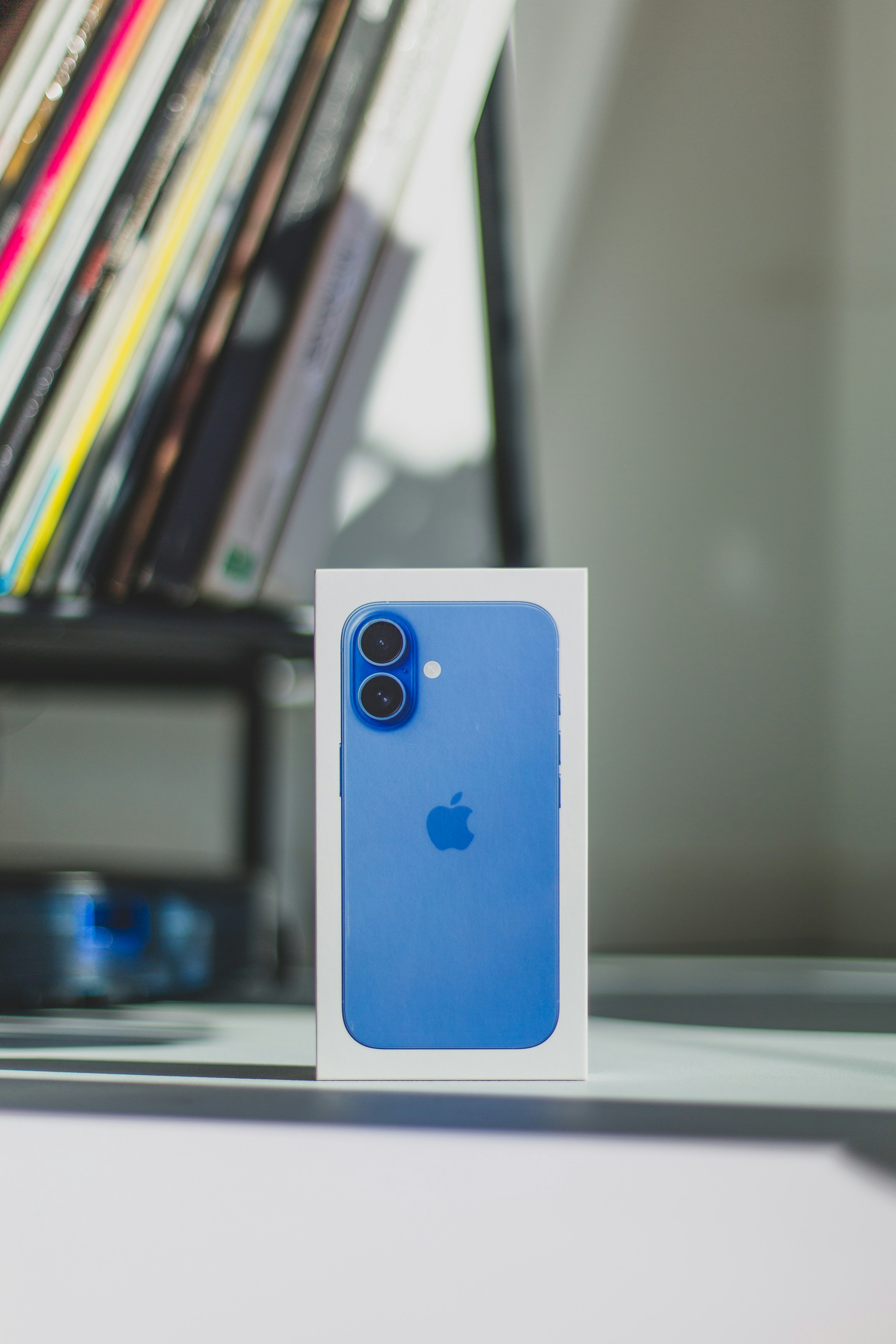 A blue iPhone case sitting on top of a table