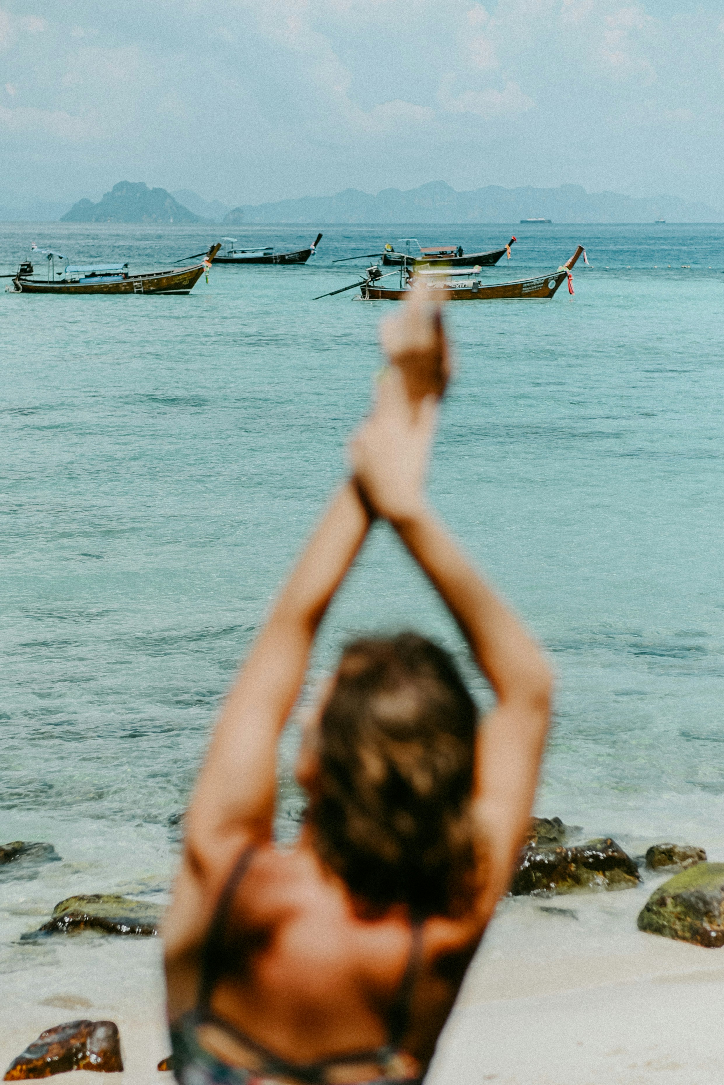 A woman in a bikini standing on a beach