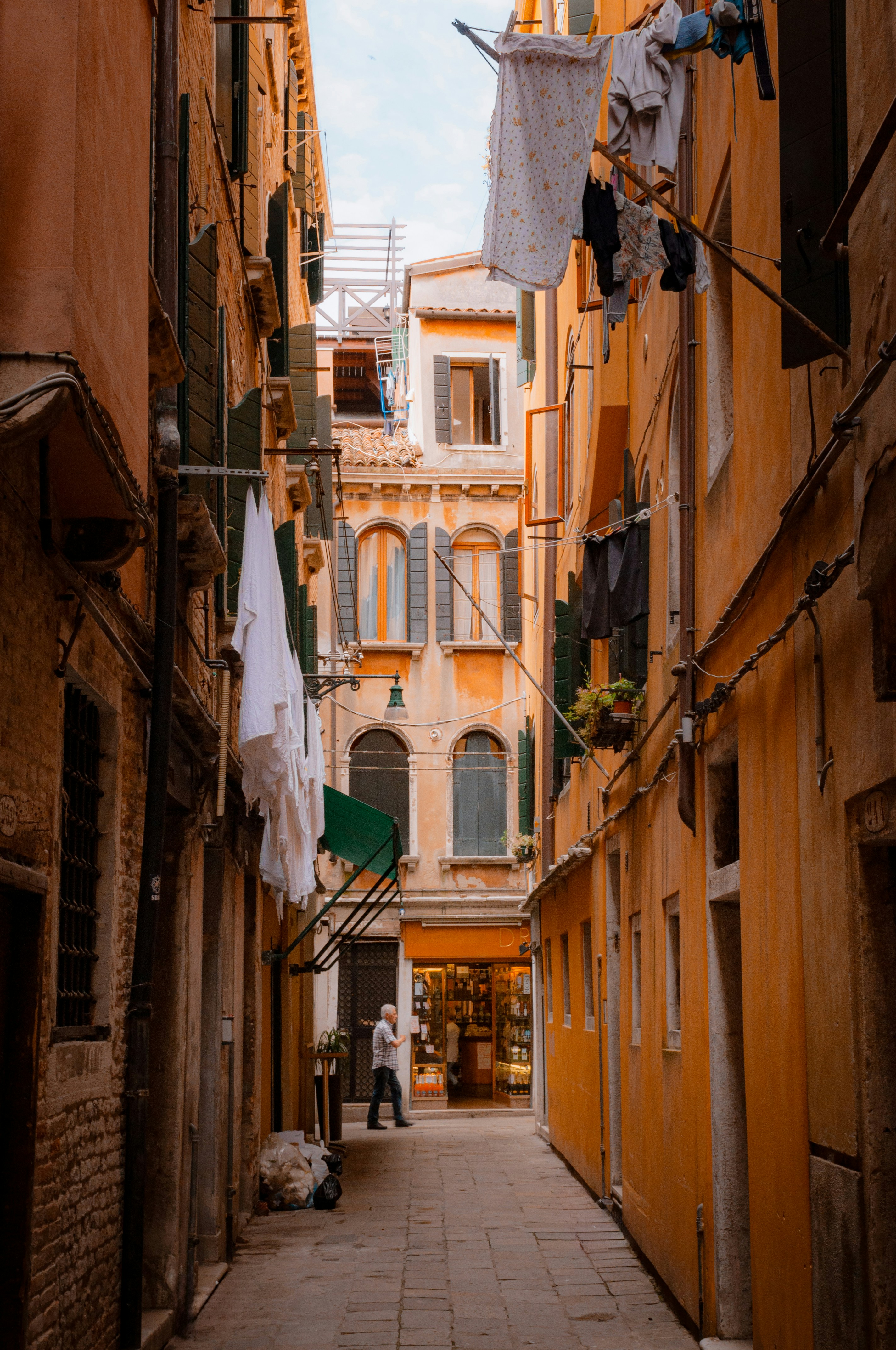 A narrow alley way with clothes hanging out to dry