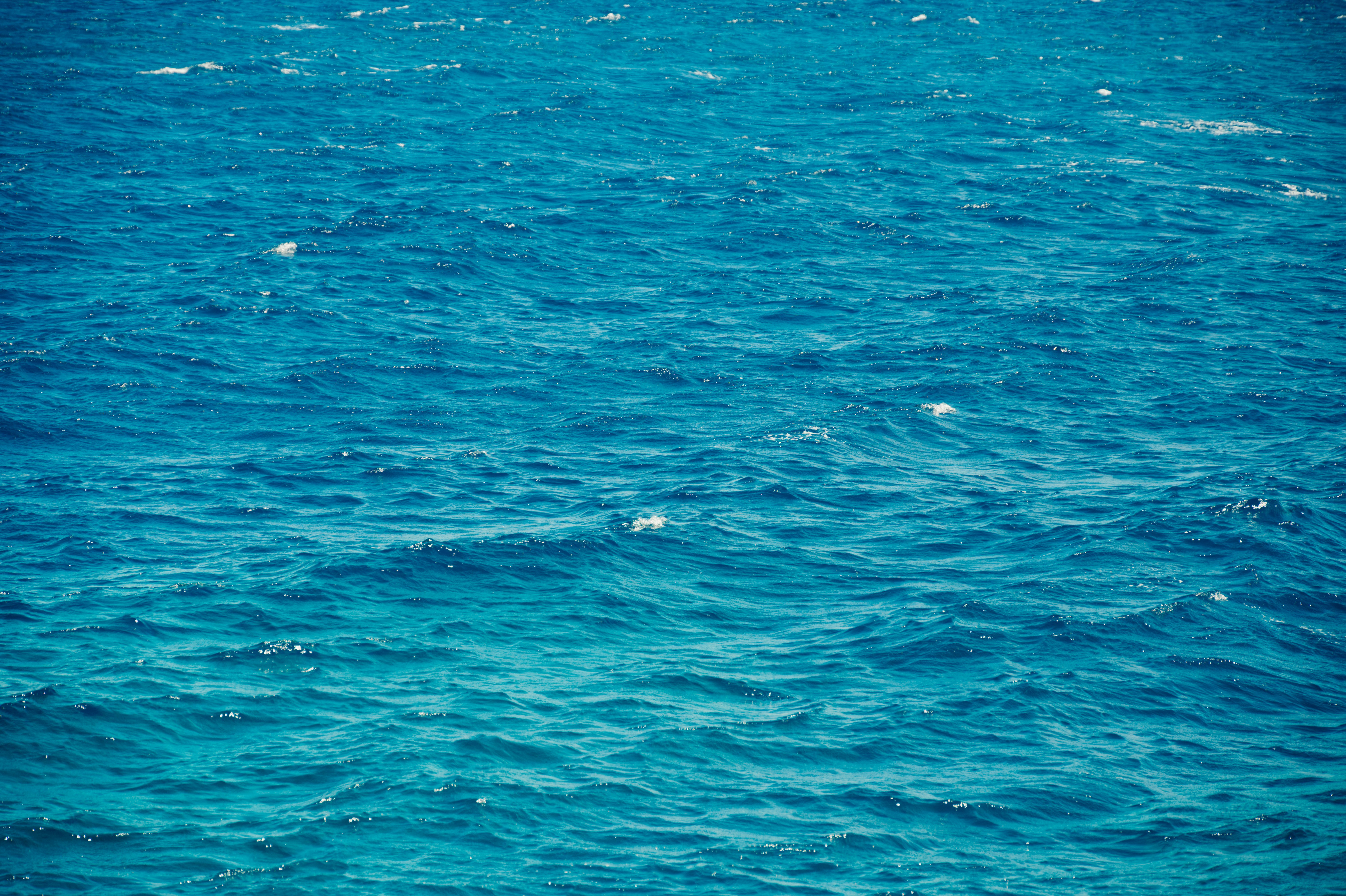 A boat floating on top of a large body of water