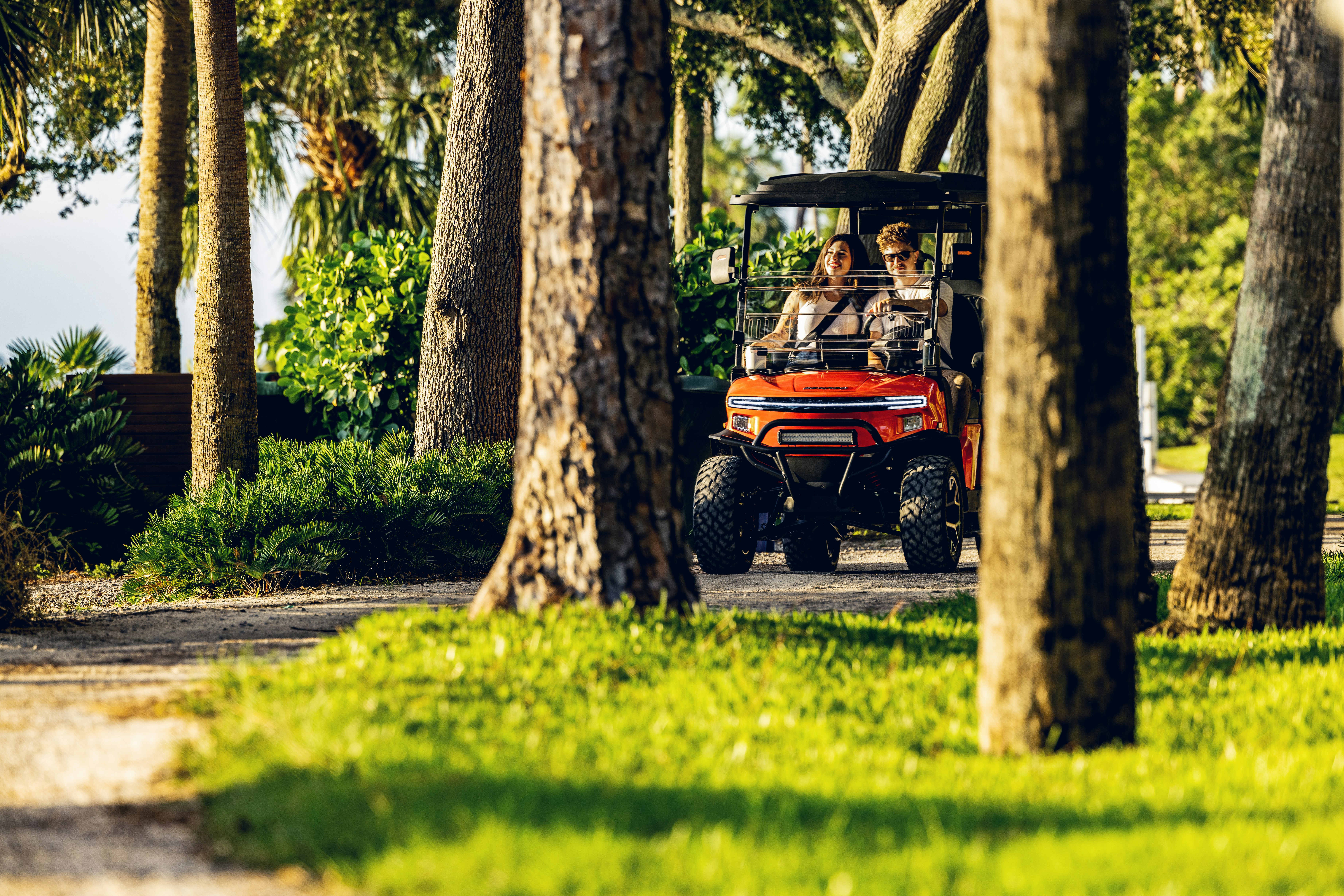 A group of people riding in a golf cart photo – Free Outdoors Image on ...