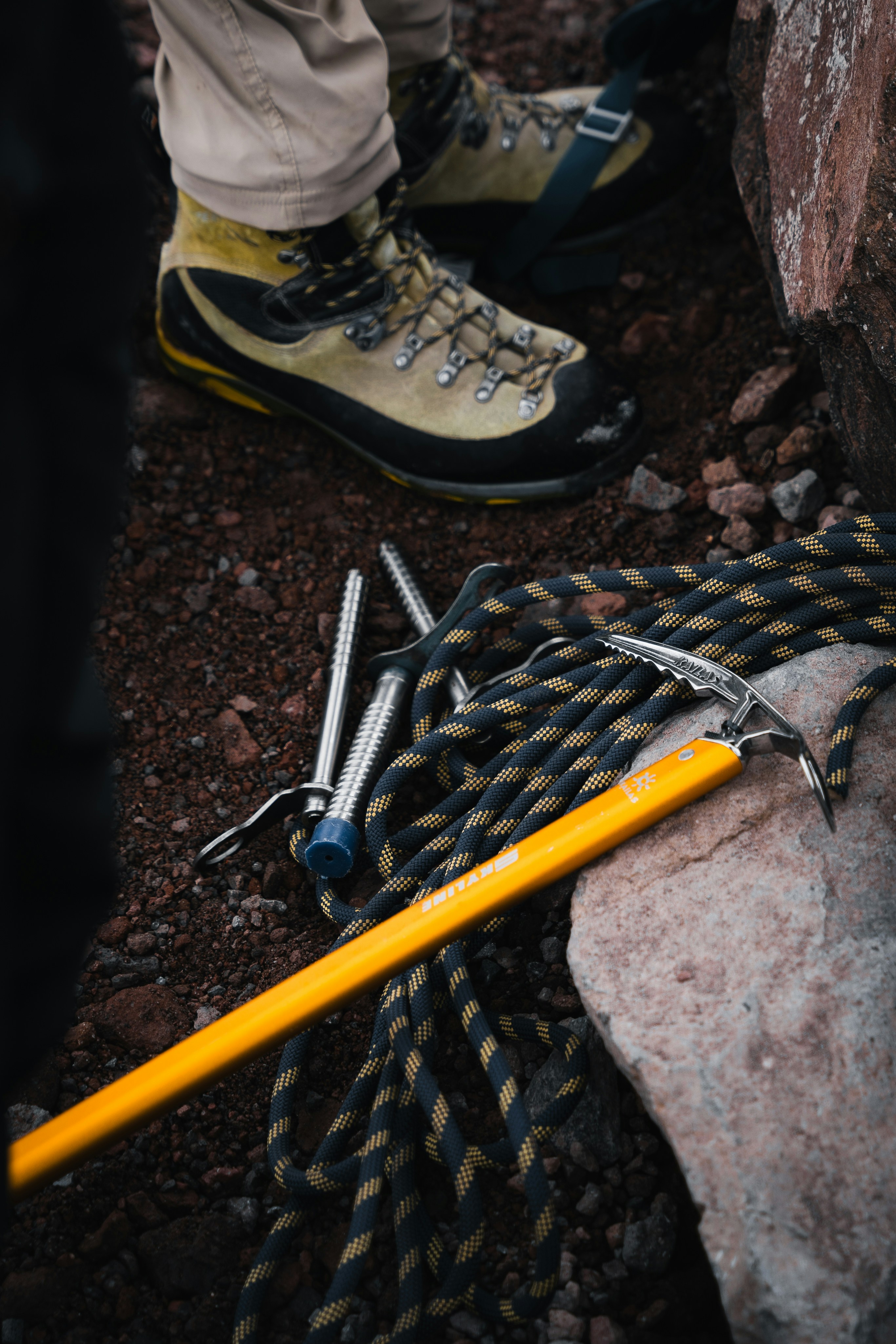 A pair of hiking boots and a pair of tools