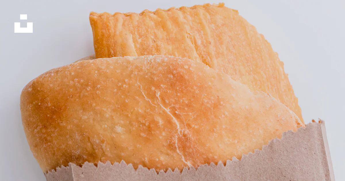 Paper Top Bread A piece of bread sitting on top of a brown paper bag photo – Free Food ...