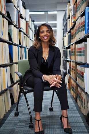 A woman sitting on a chair in a library