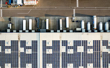 An aerial view of a parking lot with lots of solar panels