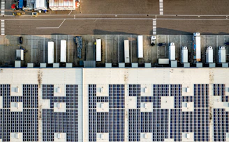 An aerial view of a parking lot with lots of solar panels