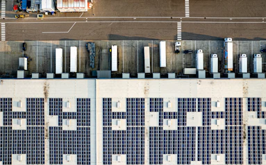 An aerial view of a parking lot with lots of solar panels