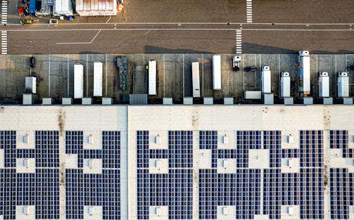 An aerial view of a parking lot with lots of solar panels