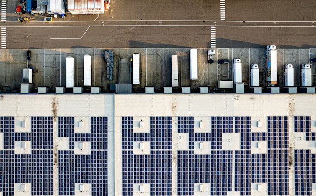 An aerial view of a parking lot with lots of solar panels