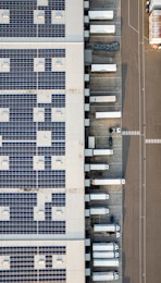 An aerial view of a parking lot with cars parked in it