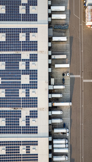 An aerial view of a parking lot with cars parked in it