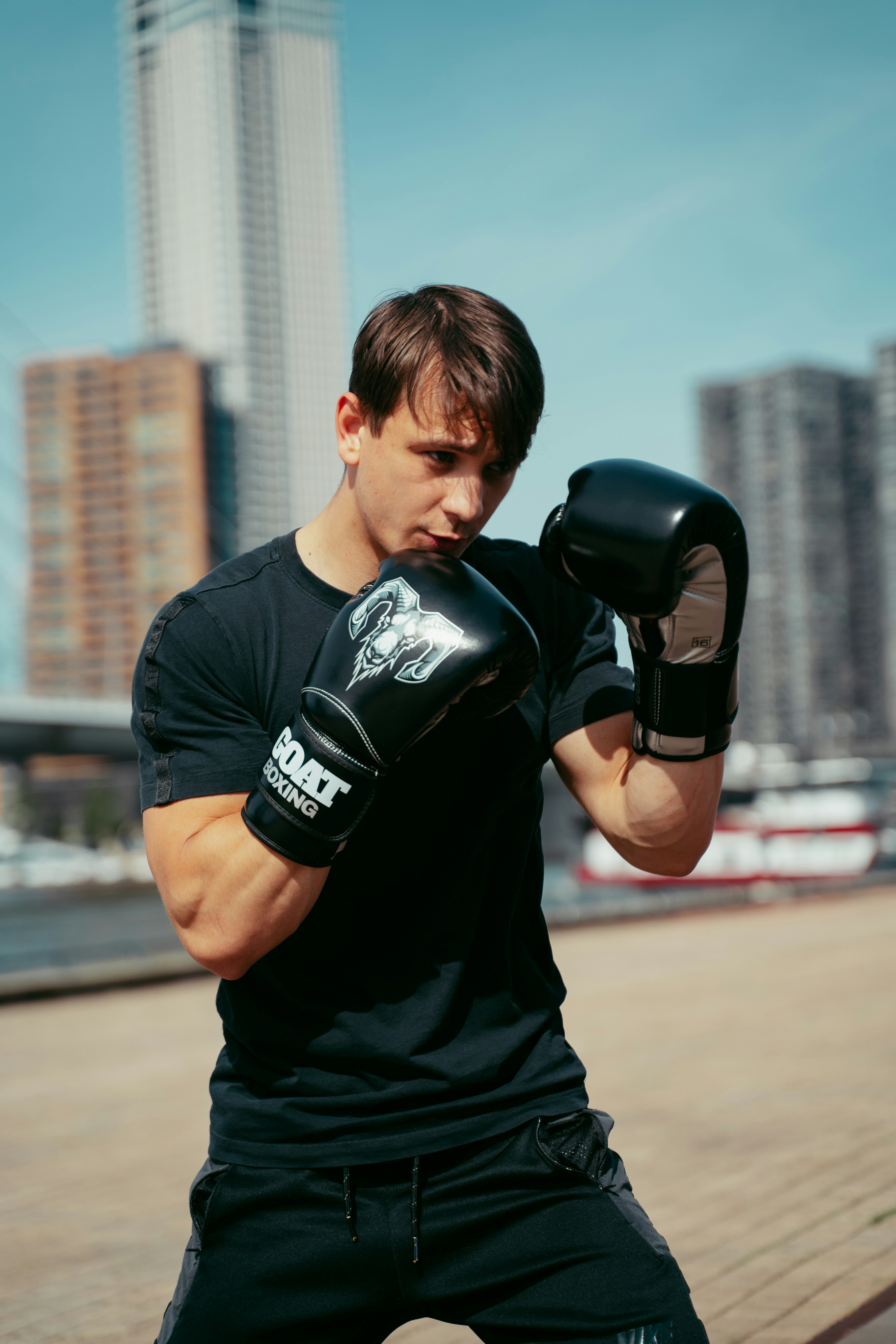 A man in black shirt and boxing gloves