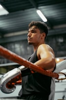 A man in a gym with a punching bag