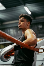 A man in a gym with a punching bag