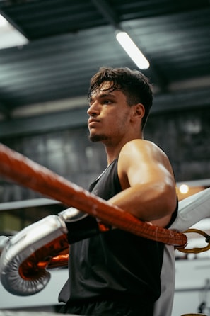 A man in a gym with a punching bag