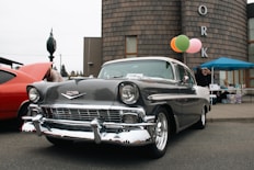 A classic car parked in front of a building
