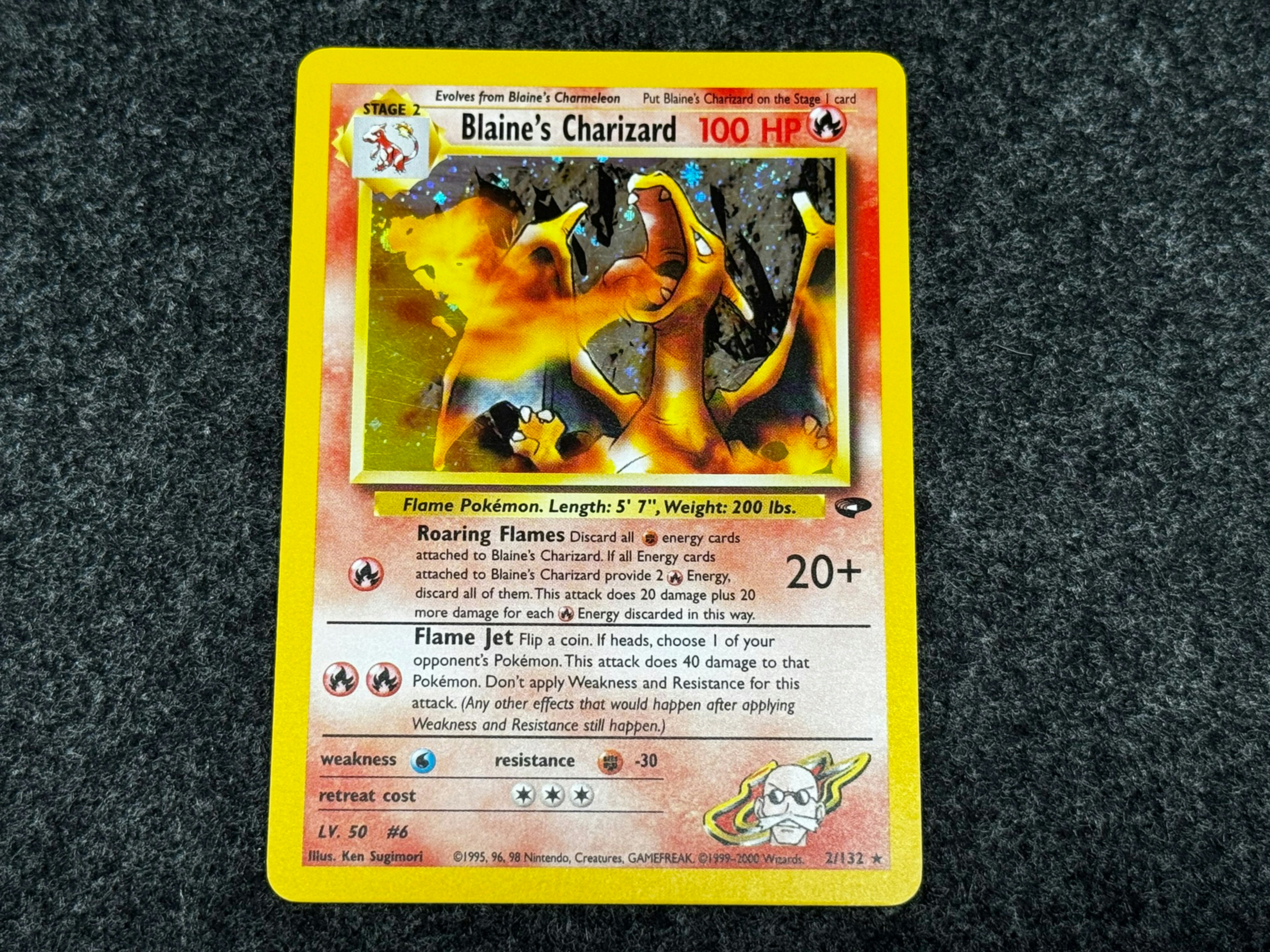 Rare holographic Charizard card under spotlight on dark background