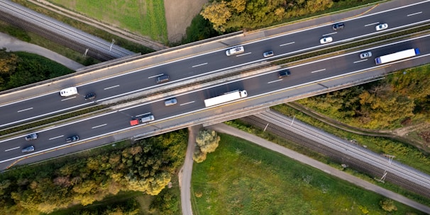 An aerial view of a highway intersection with cars on it
