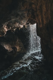 A cave with a waterfall coming out of it