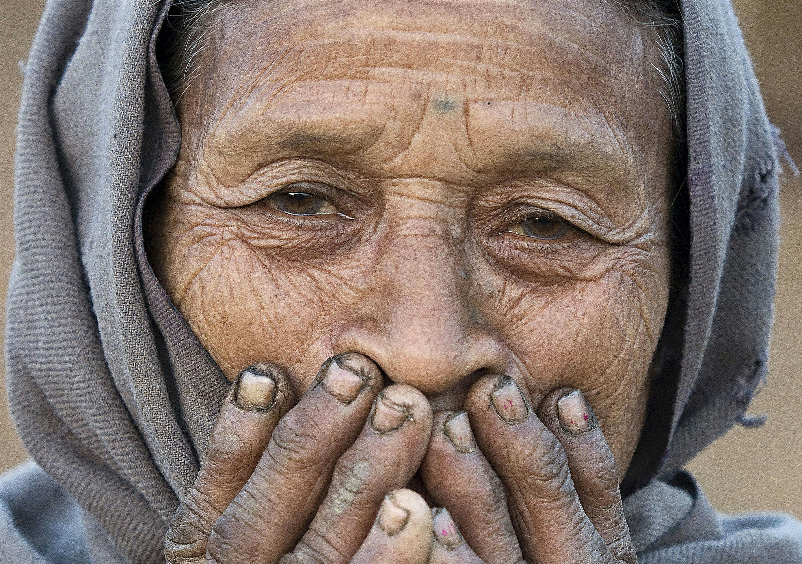 A woman with her hands covering her mouth