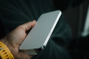 A person holding a white device in their hand