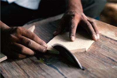 A person is working on a piece of wood