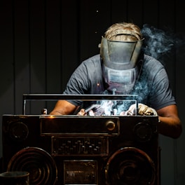 A man in a gas mask working on a radio