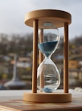 An hourglass sitting on top of a wooden table