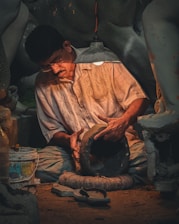 A man sitting on the ground working on something