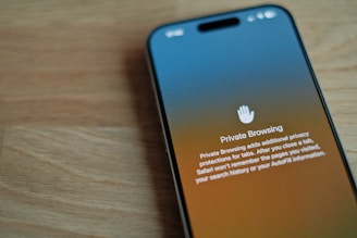 A cell phone sitting on top of a wooden table