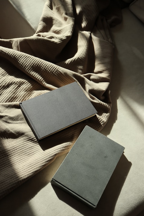 A couple of books sitting on top of a bed