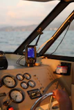 A man driving a boat on a body of water