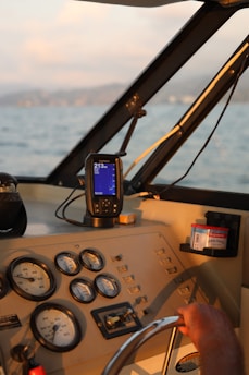 A man driving a boat on a body of water