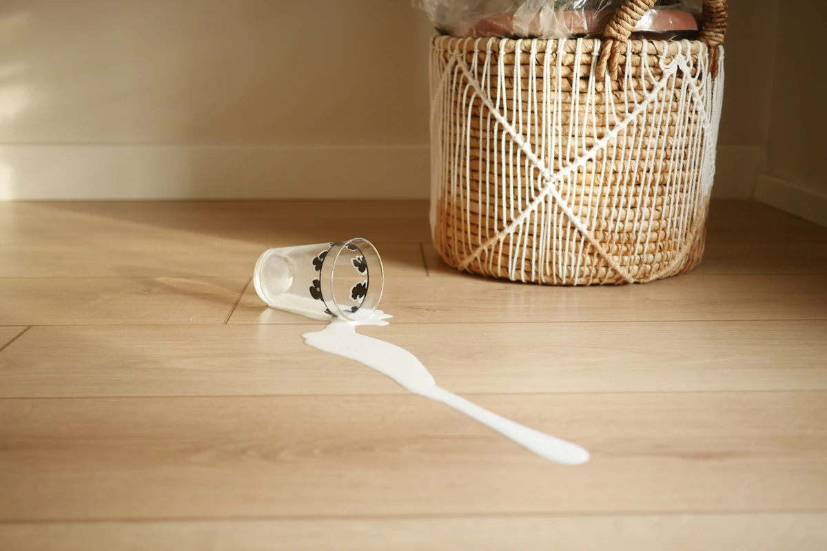 A basket with a toothbrush on a wooden floor