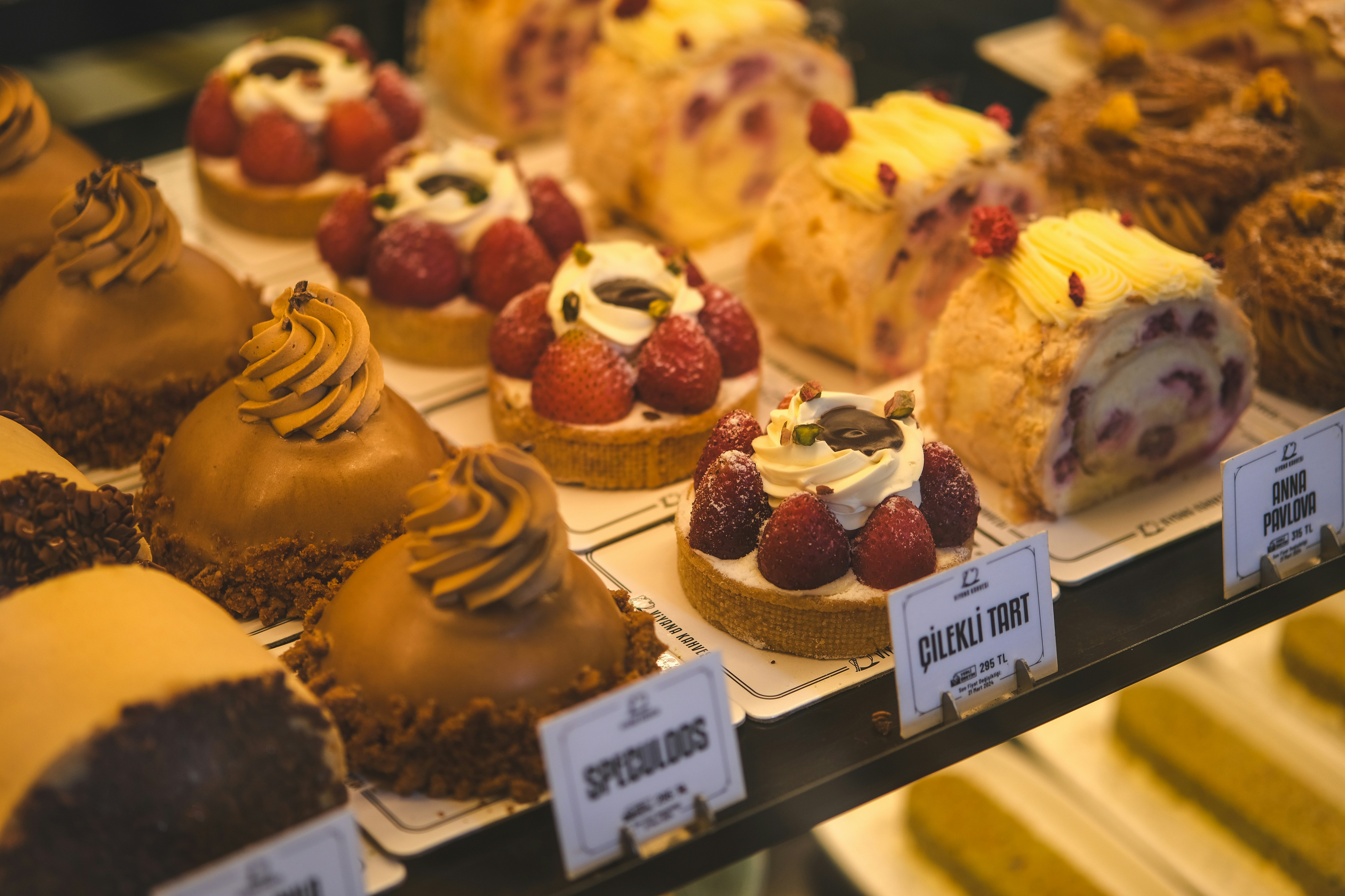 A display case filled with lots of different types of cakes