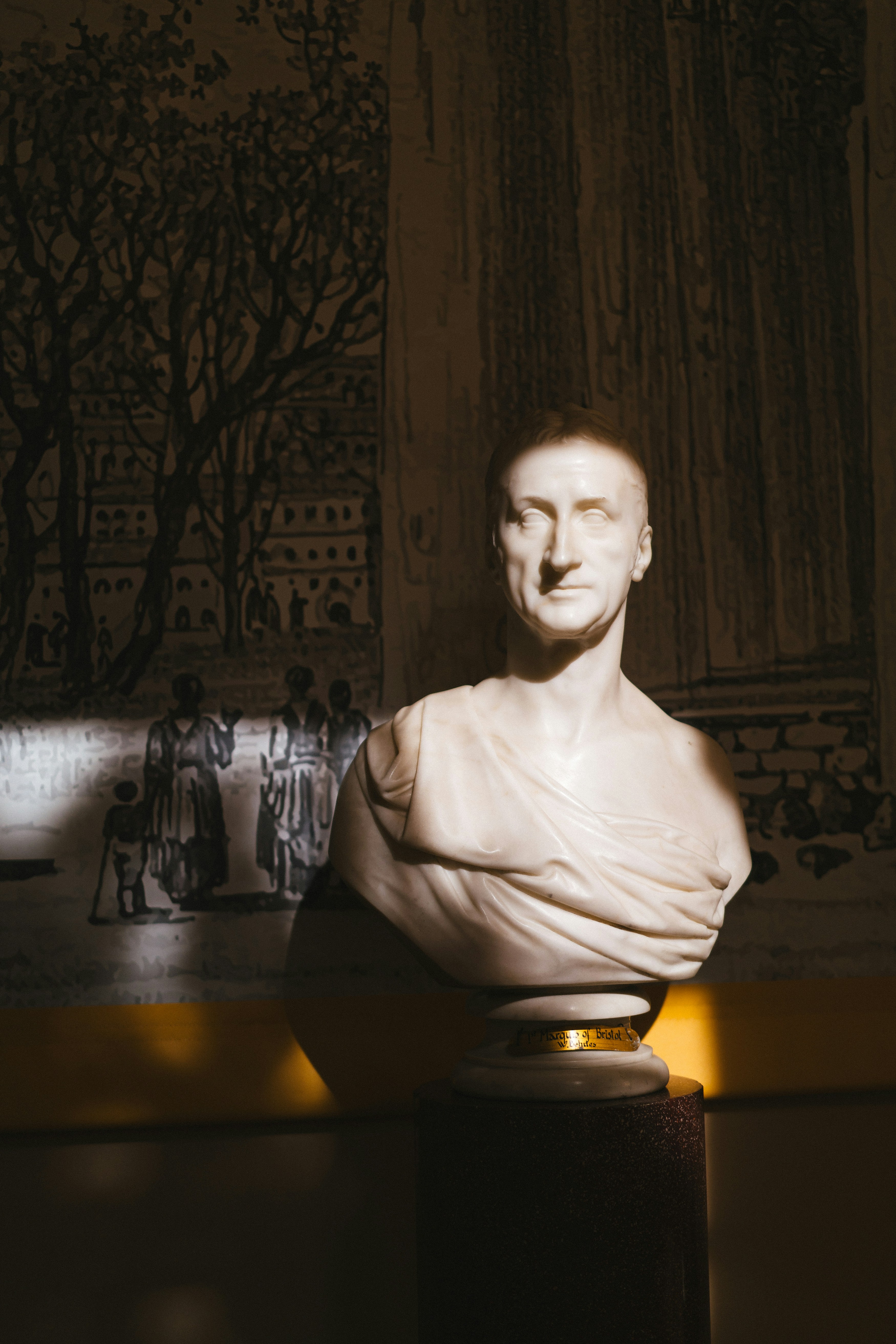 A bust of a man sitting in a room