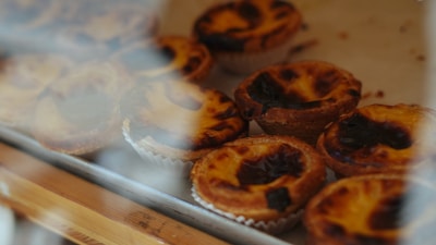 A close up of some pastries behind a glass