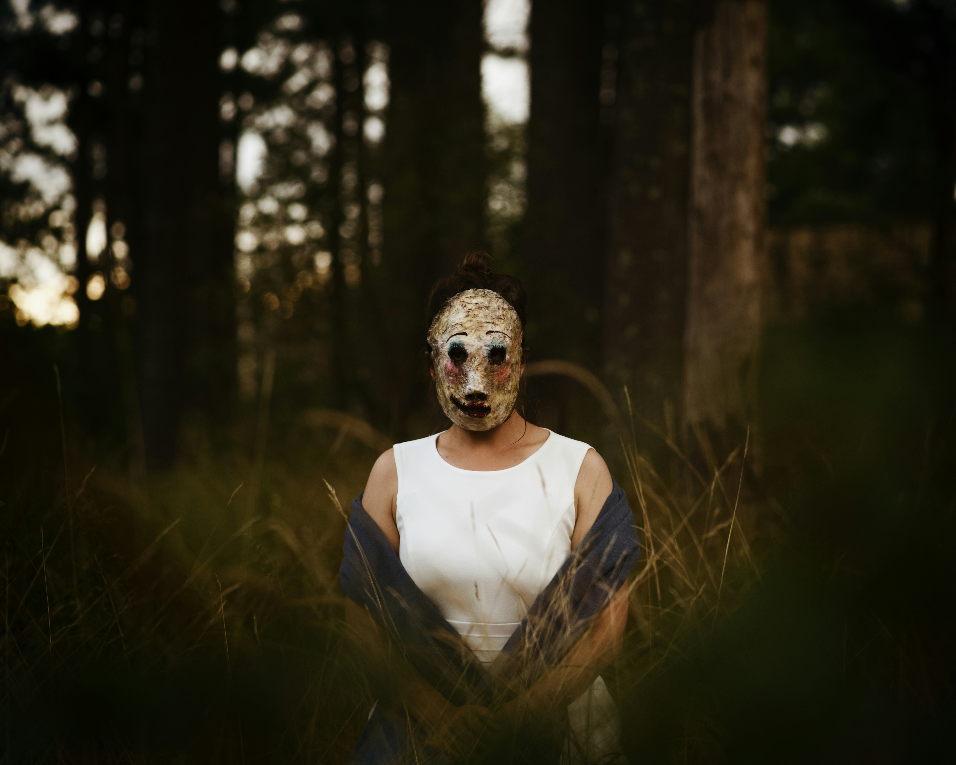 A woman wearing a mask in a forest