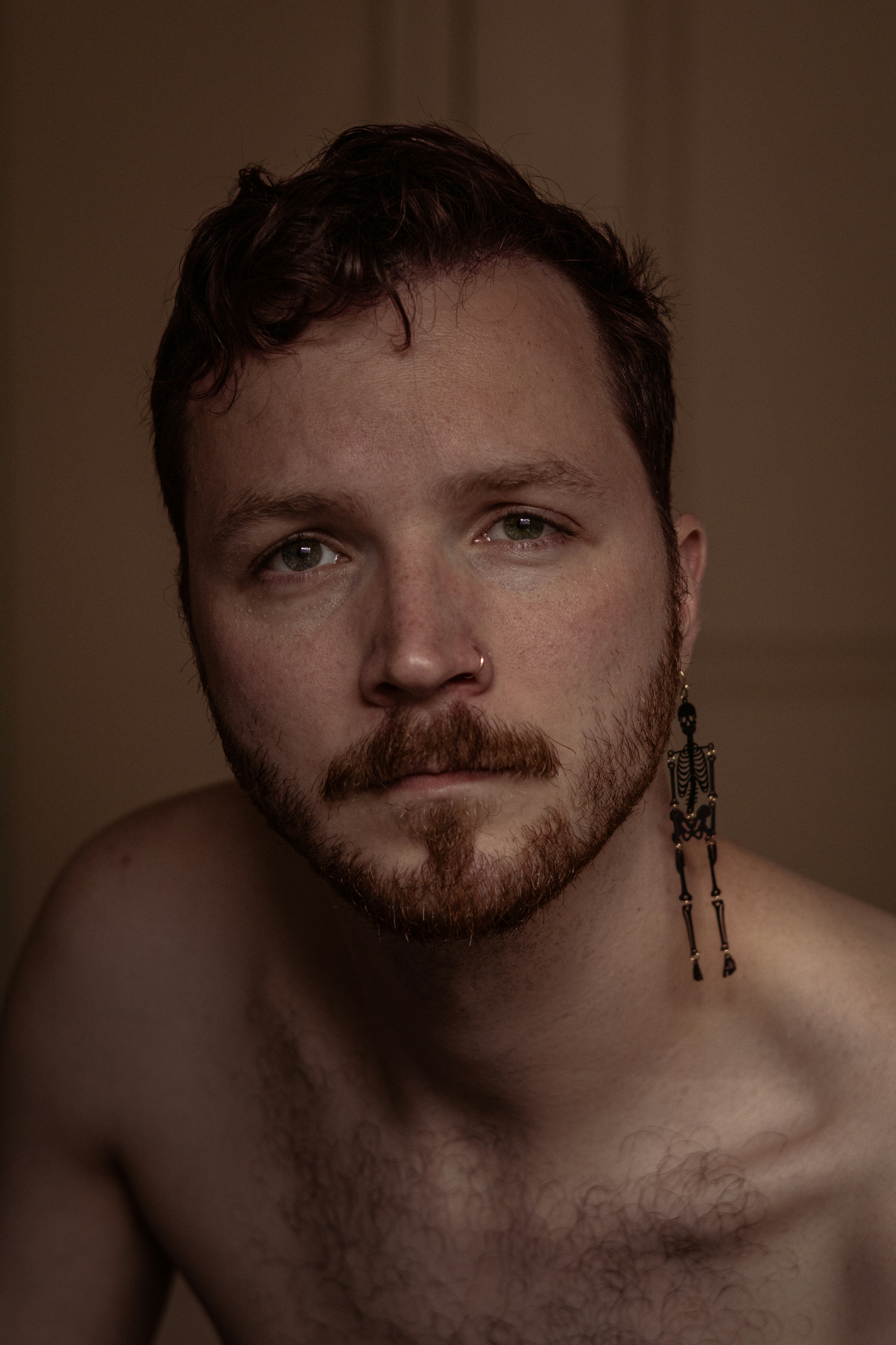 A shirtless man with no shirt on posing for a picture