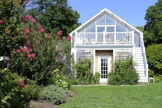 A white house with a porch and a deck