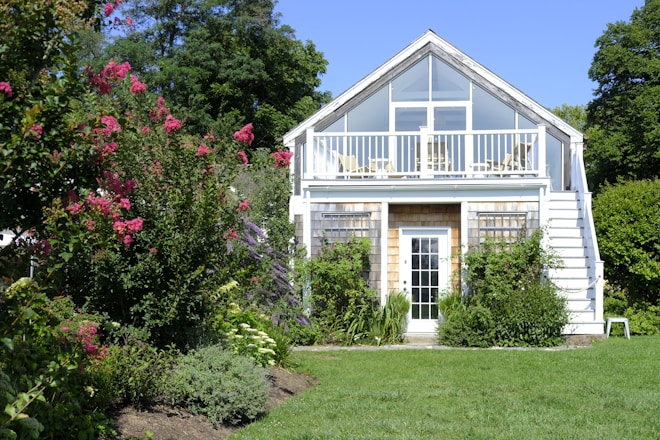A white house with a porch and a deck