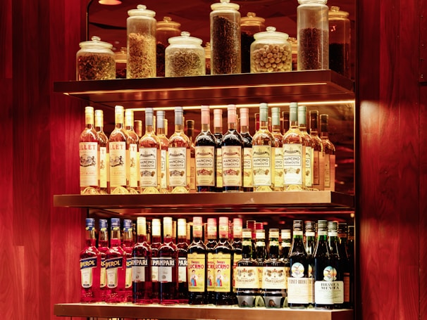 A shelf filled with lots of bottles of liquor