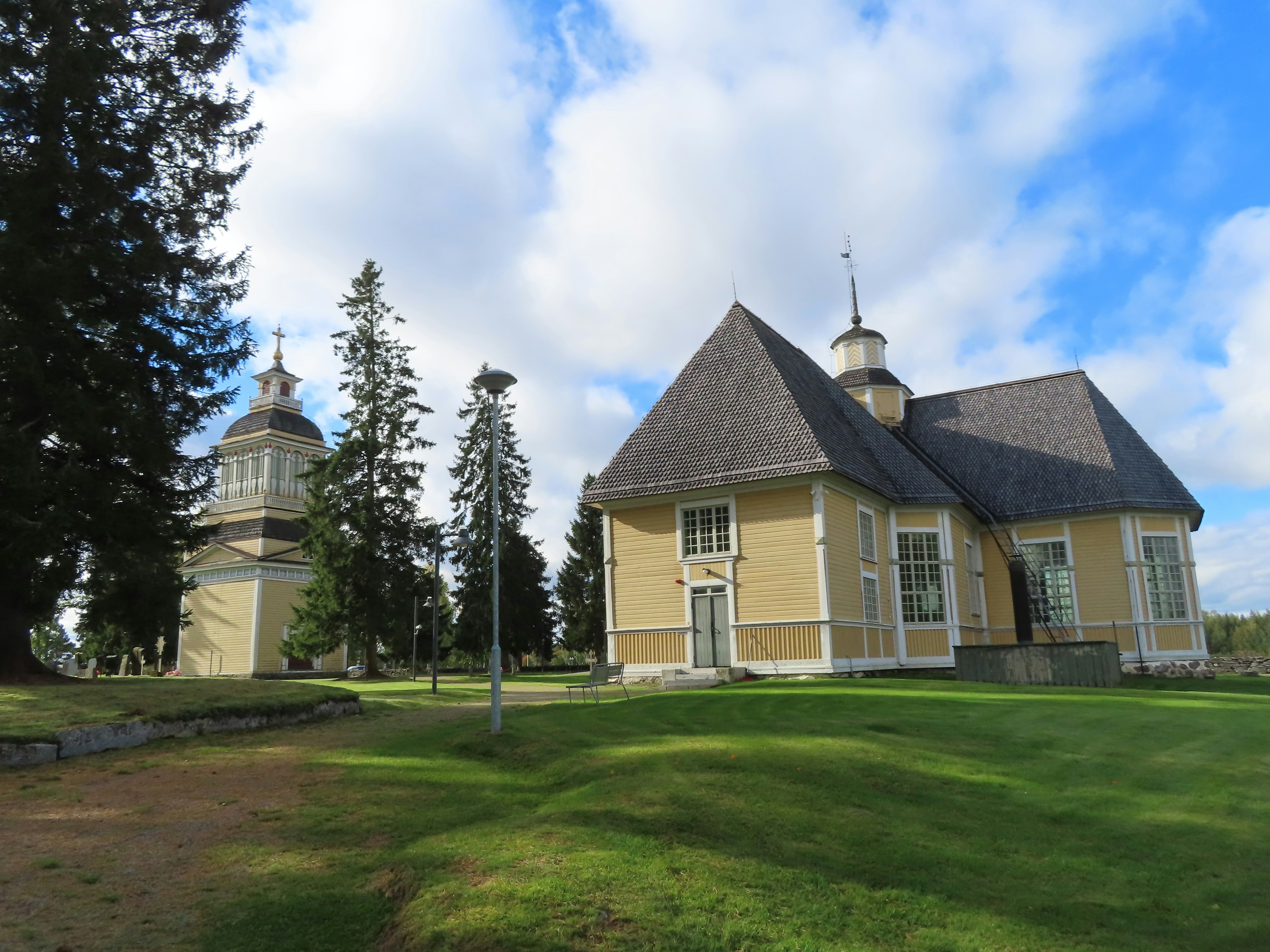 A large yellow house with two towers on top of it