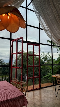 A dining room with a view of the outdoors