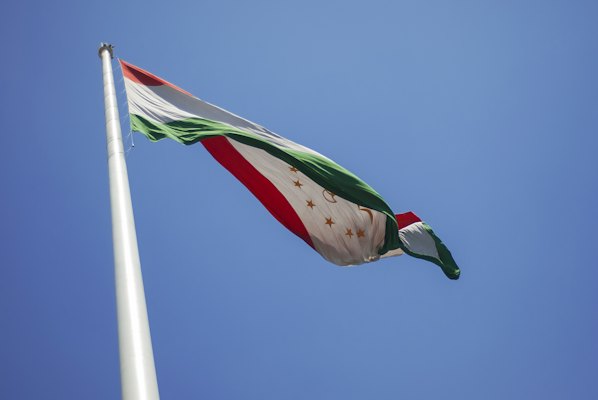 A flag flying in the wind on a clear day — Dushanbe, Tajikistan