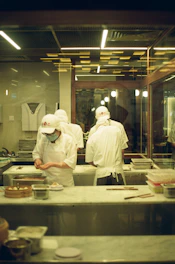 A group of chefs preparing food inside of a kitchen
