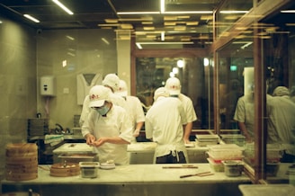 A group of chefs preparing food in a kitchen