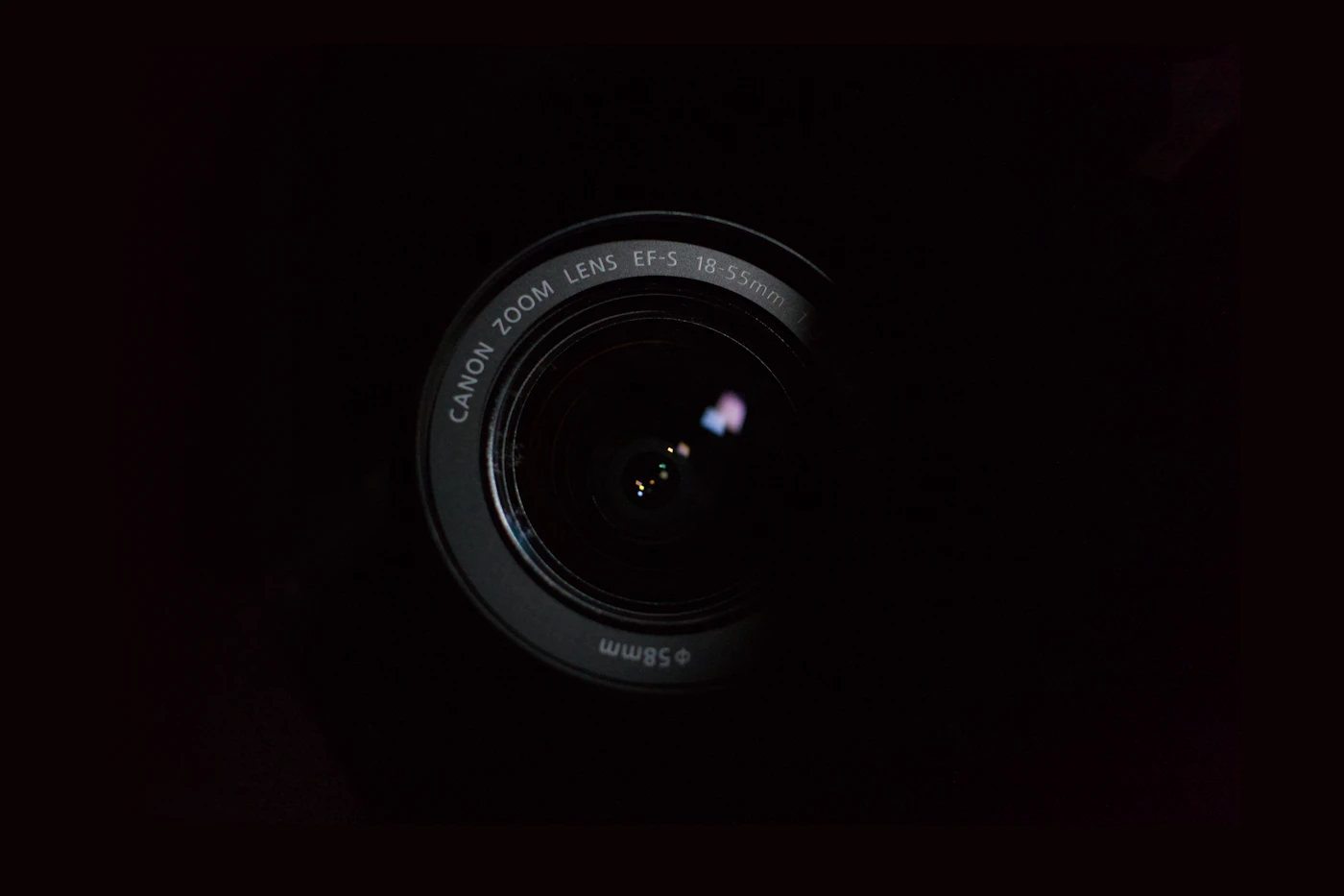 Camera lens photographed against a dark background