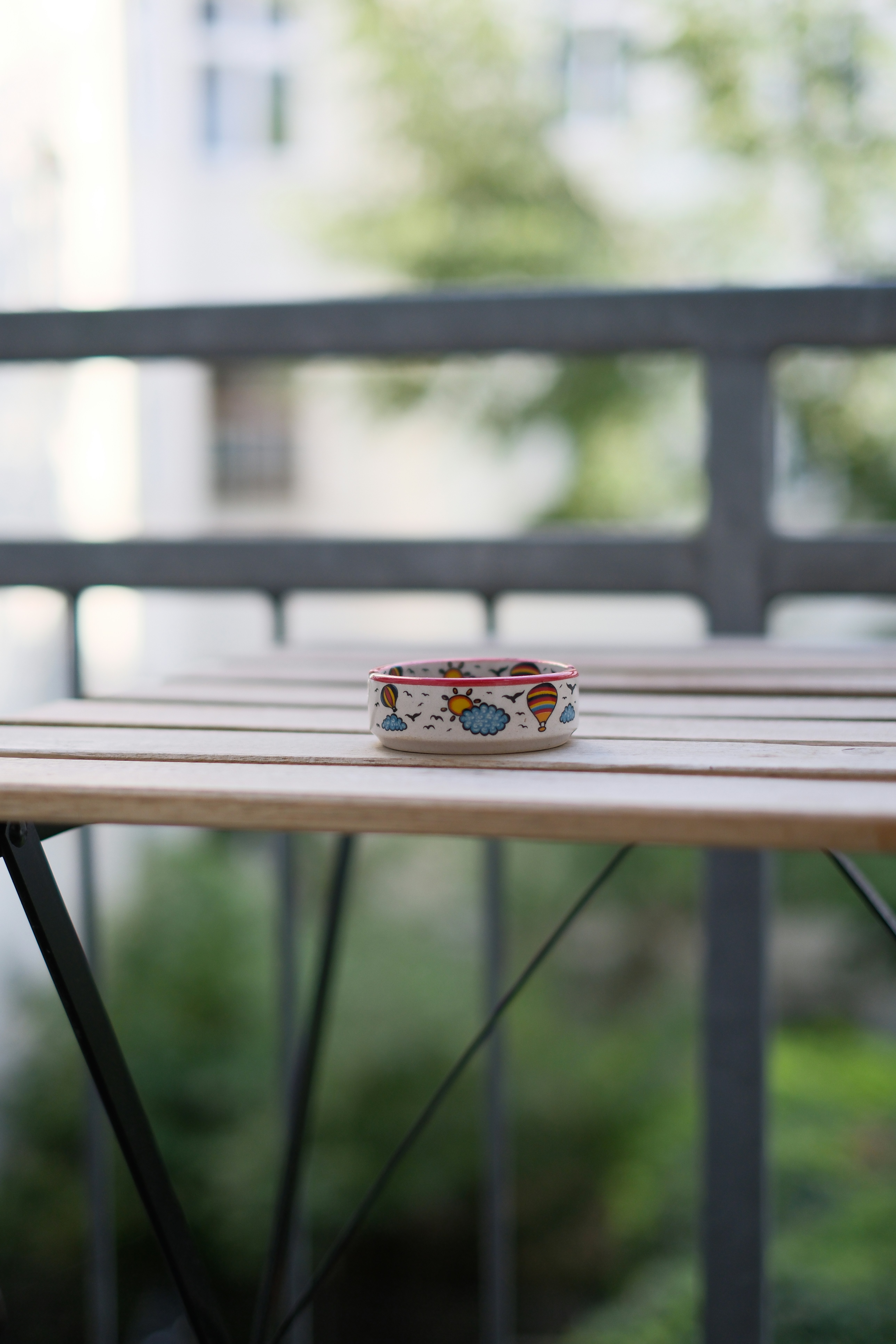 A small ring sitting on top of a wooden bench - a-small-ring-sitting-on-top-of-a-wooden-bench-JCSqoZVlfiw