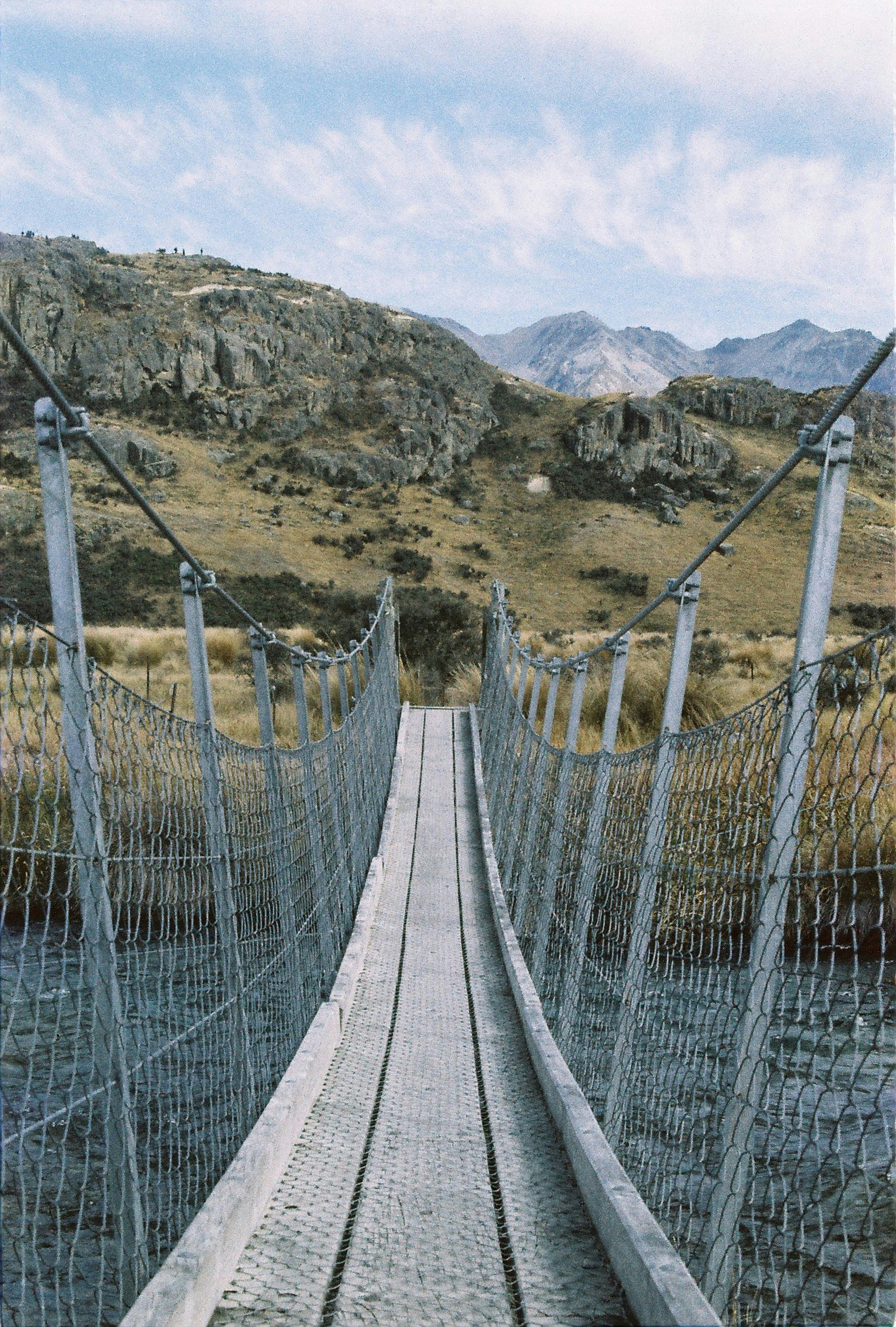 A suspension bridge in the middle of a mountain range